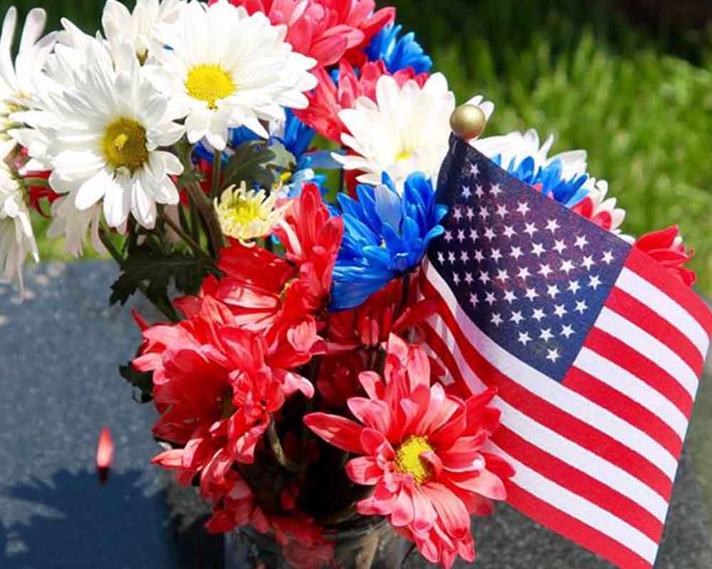 Flowers and US flag at the memorial